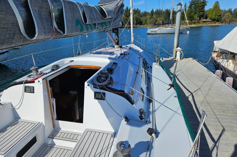 Slide: The Image of Sailboat docked at marina, Farr 395 model, 2001, with visible deck and rigging. - 8