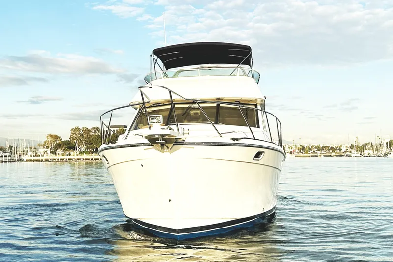 Slide: The Image of 2002 Bayliner 3988 Command Bridge Motoryacht on calm water, front view. - 16