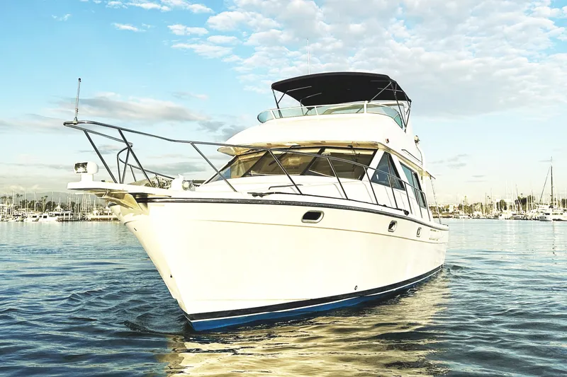 Slide: The Image of 2002 Bayliner 3988 Command Bridge Motoryacht on calm water under a blue sky. - 17