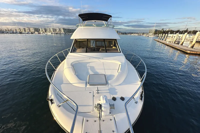 Slide: The Image of 2002 Bayliner 3988 Command Bridge Motoryacht on calm water near marina. - 18
