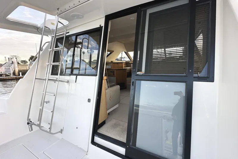 Slide: The Image of 2002 Bayliner 3988 Command Bridge Motoryacht with sliding glass door and ladder. - 21