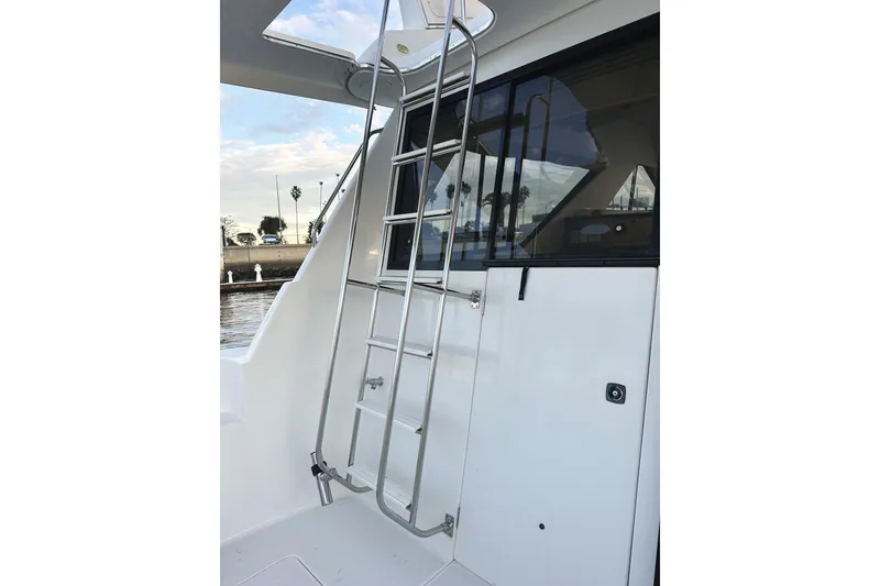 Slide: The Image of 2002 Bayliner 3988 Command Bridge Motoryacht with stainless steel ladder and window view. - 22