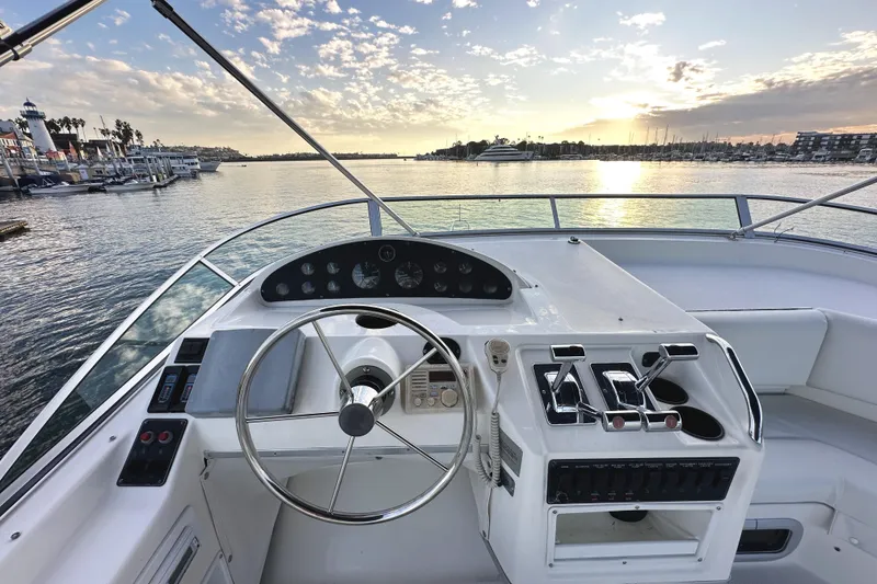 Slide: The Image of 2002 Bayliner 3988 Command Bridge Motoryacht helm with ocean view at sunset. - 25
