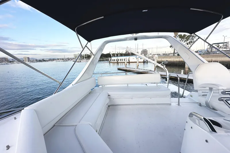 Slide: The Image of 2002 Bayliner 3988 Command Bridge Motoryacht with spacious seating, docked at a marina. - 26