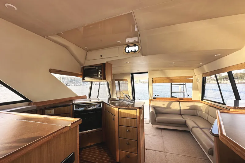 Slide: The Image of Interior of 2002 Bayliner 3988 Command Bridge Motoryacht with kitchen and seating area. - 31