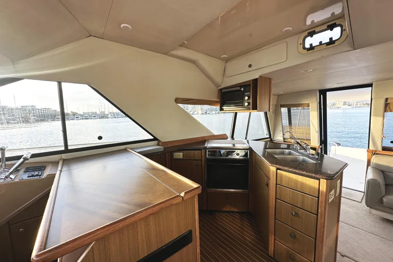 Slide: The Image of Luxurious 2002 Bayliner 3988 Command Bridge Motoryacht interior with modern kitchen and scenic water views. - 32