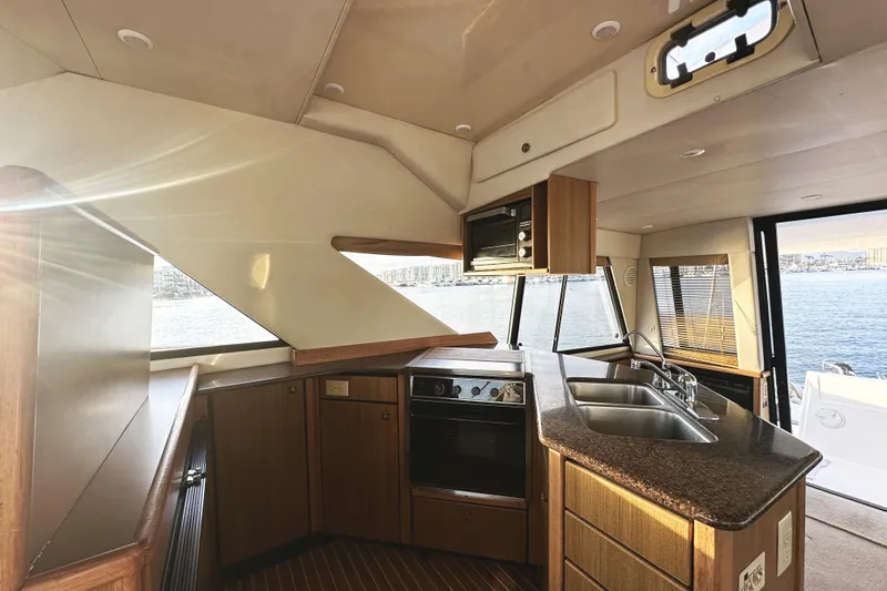 Slide: The Image of Interior of 2002 Bayliner 3988 Command Bridge Motoryacht with modern kitchen and ocean view. - 33