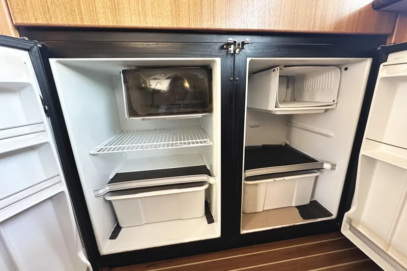 Slide: The Image of Open refrigerator and freezer in 2002 Bayliner 3988 Command Bridge Motoryacht kitchen. - 37