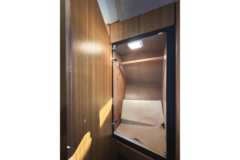 Slide: The Image of Interior closet of 2002 Bayliner 3988 Command Bridge Motoryacht with wooden finish and lighting. - 40