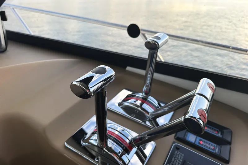 Slide: The Image of Control levers on 2002 Bayliner 3988 Command Bridge Motoryacht, overlooking water. - 46