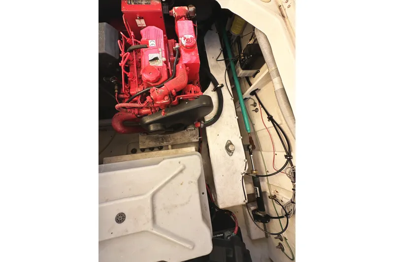 Slide: The Image of Engine compartment of 2002 Bayliner 3988 Command Bridge Motoryacht, featuring red engine components. - 51