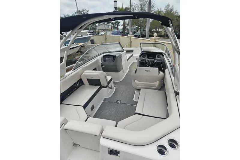 Slide: The Image of 2018 Chaparral 250 Suncoast boat interior with spacious seating and modern dashboard. - 5