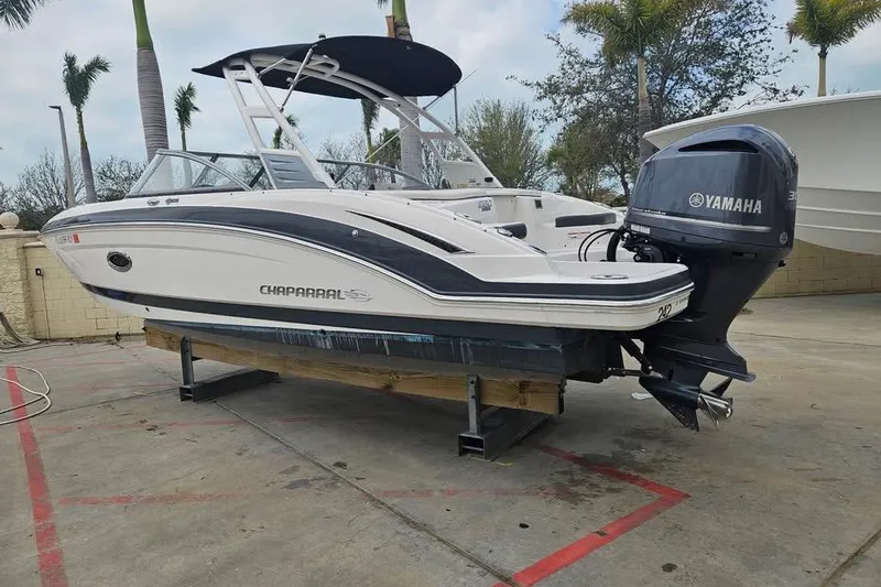 Slide: The Image of 2018 Chaparral 250 Suncoast boat with Yamaha engine on display outdoors. - 9