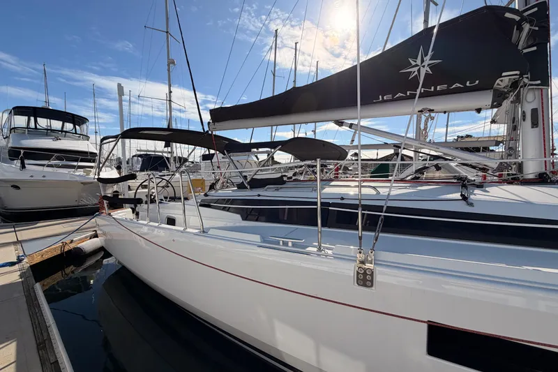 Slide: The Image of 2025 Jeanneau Sun Odyssey 350 sailboat docked at marina under clear blue sky. - 10