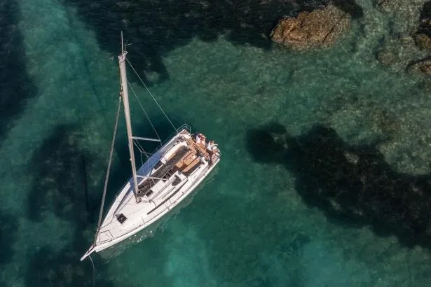 Slide: The Image of Manufacturer Provided Image: Aerial view of 2025 Jeanneau Sun Odyssey 350 sailing in clear turquoise waters. - 100