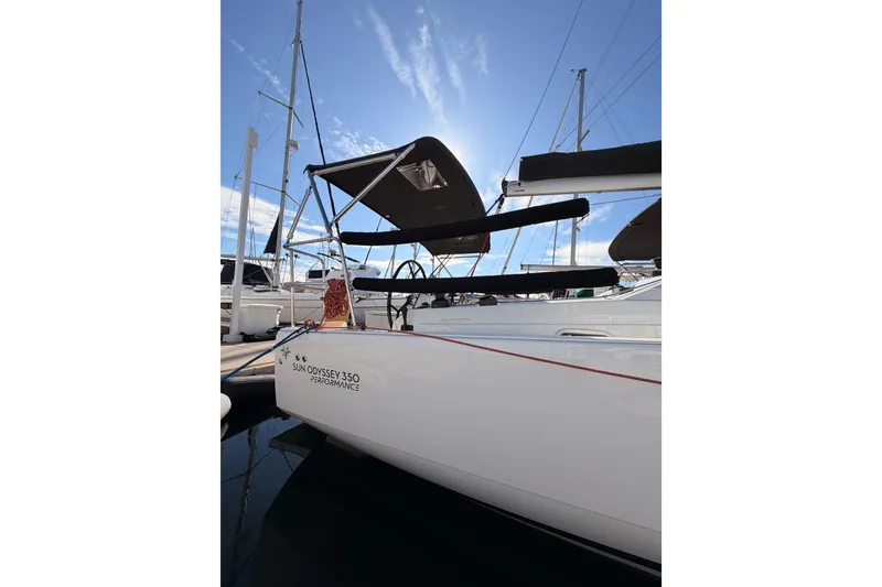 Slide: The Image of 2025 Jeanneau Sun Odyssey 350 sailboat docked, showcasing sleek design and performance features. - 11