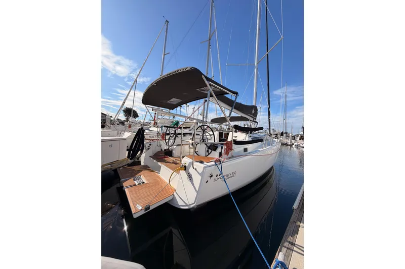 Slide: The Image of 2025 Jeanneau Sun Odyssey 350 sailboat docked at marina under clear blue sky. - 12