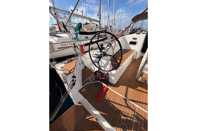 Slide: The Image of 2025 Jeanneau Sun Odyssey 350 sailboat cockpit with wooden deck and steering wheel. - 17