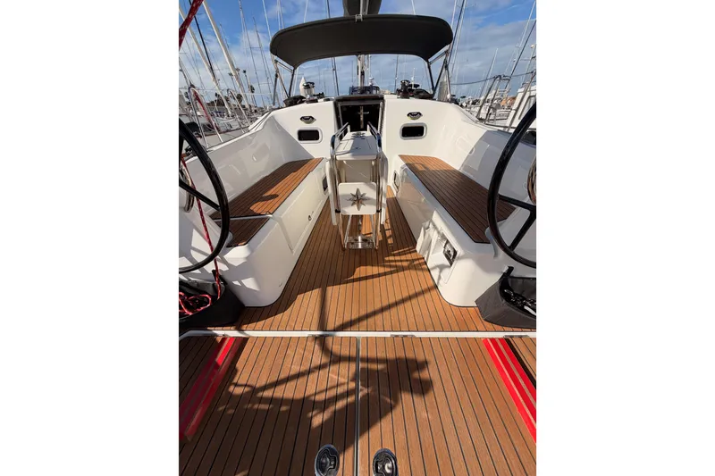 Slide: The Image of 2025 Jeanneau Sun Odyssey 350 cockpit with dual steering wheels and teak flooring. - 18