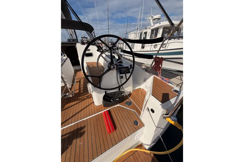 Slide: The Image of 2025 Jeanneau Sun Odyssey 350 sailboat cockpit with wooden deck and steering wheel. - 19