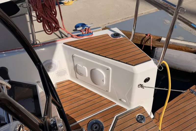 Slide: The Image of Cockpit of 2025 Jeanneau Sun Odyssey 350 sailboat with teak decking and nautical equipment. - 20