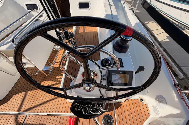 Slide: The Image of Steering wheel of 2025 Jeanneau Sun Odyssey 350 sailboat with navigation controls. - 21