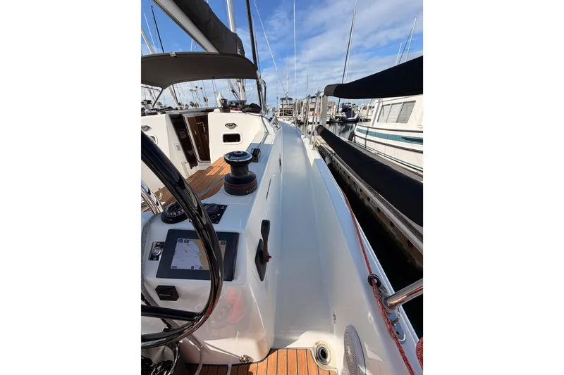 Slide: The Image of 2025 Jeanneau Sun Odyssey 350 sailboat cockpit with navigation equipment and marina view. - 23