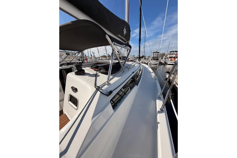 Slide: The Image of 2025 Jeanneau Sun Odyssey 350 sailboat docked at marina under clear blue sky. - 25