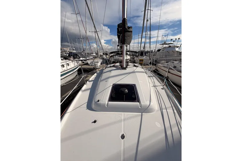 Slide: The Image of 2025 Jeanneau Sun Odyssey 350 sailboat docked at marina under cloudy sky. - 32