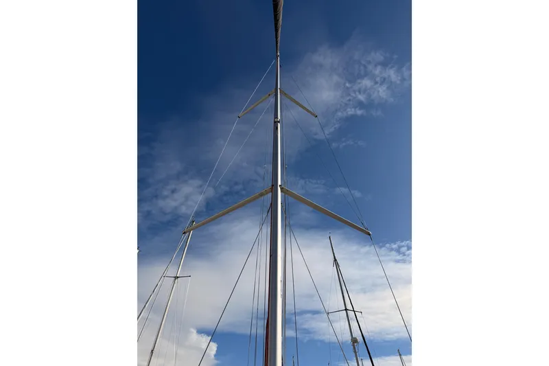 Slide: The Image of Mast of 2025 Jeanneau Sun Odyssey 350 sailboat against a clear blue sky. - 33