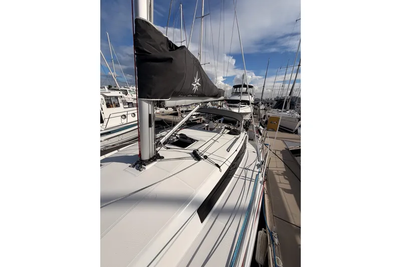 Slide: The Image of 2025 Jeanneau Sun Odyssey 350 sailboat docked at marina under blue sky. - 34