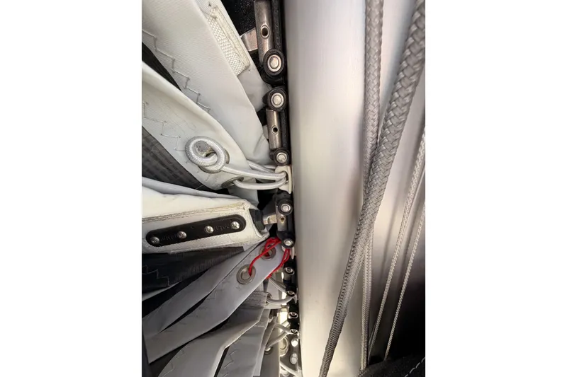 Slide: The Image of Close-up of Jeanneau Sun Odyssey 350 sailboat rigging, showcasing detailed sail attachments. - 35