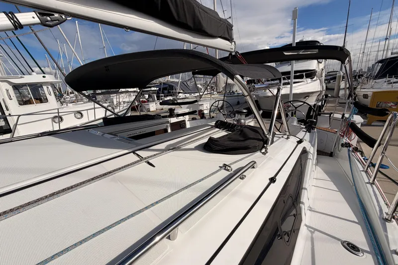 Slide: The Image of 2025 Jeanneau Sun Odyssey 350 sailboat docked, showcasing sleek design and modern features. - 38