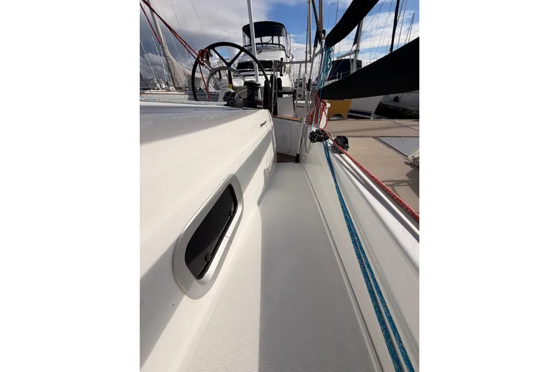 Slide: The Image of 2025 Jeanneau Sun Odyssey 350 sailboat deck with ropes and steering wheel. - 40
