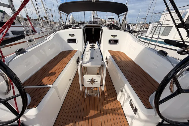Slide: The Image of 2025 Jeanneau Sun Odyssey 350 yacht cockpit with teak flooring and dual steering wheels. - 41