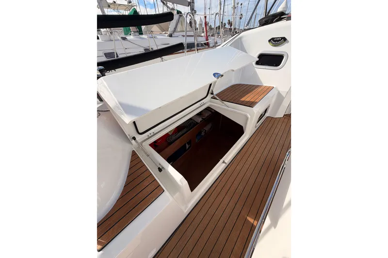 Slide: The Image of 2025 Jeanneau Sun Odyssey 350 sailboat with open storage compartment on teak deck. - 45