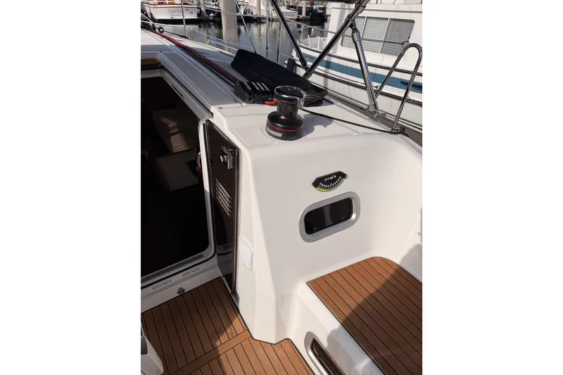Slide: The Image of 2025 Jeanneau Sun Odyssey 350 yacht deck with winch and teak flooring. - 49