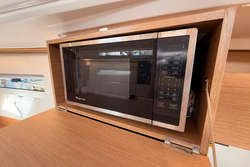 Slide: The Image of Microwave in 2025 Jeanneau Sun Odyssey 350 yacht interior, wooden cabinetry. - 59