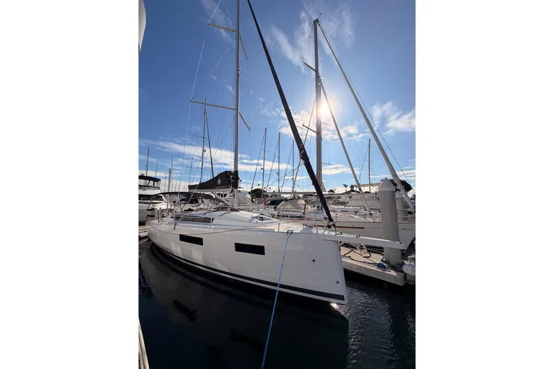 Slide: The Image of 2025 Jeanneau Sun Odyssey 350 sailboat docked under clear blue sky. - 6