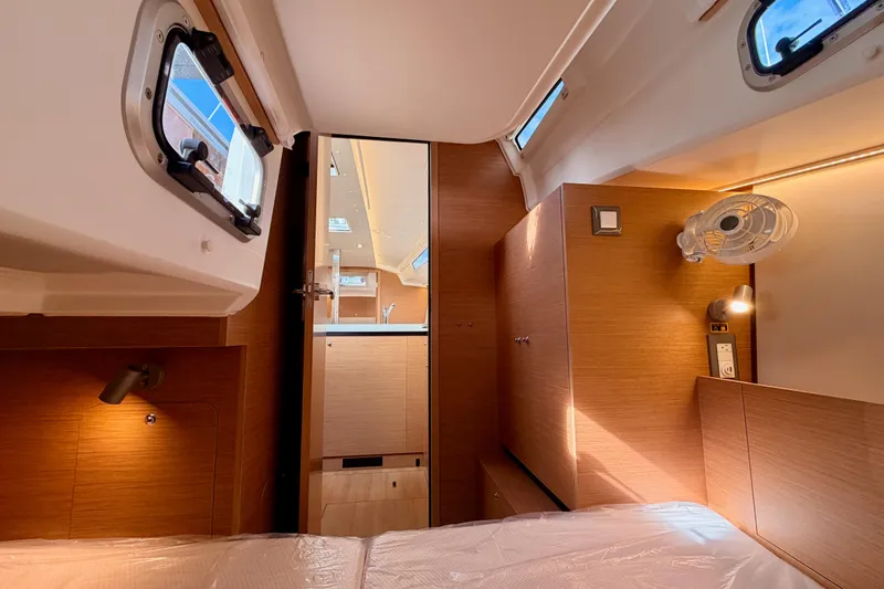 Slide: The Image of 2025 Jeanneau Sun Odyssey 350 cabin interior with modern wood finish and natural light. - 63