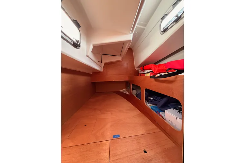 Slide: The Image of 2025 Jeanneau Sun Odyssey 350 interior cabin with wooden finish and storage compartments. - 70