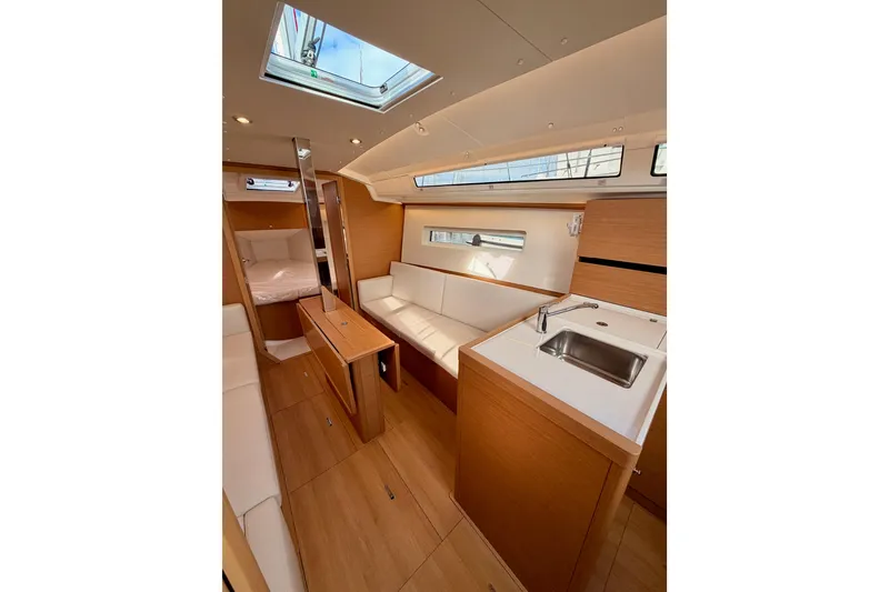 Slide: The Image of Interior of 2025 Jeanneau Sun Odyssey 350 yacht, featuring modern design and cozy seating area. - 72