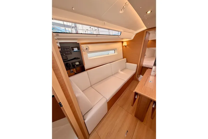 Slide: The Image of Interior of 2025 Jeanneau Sun Odyssey 350 yacht, featuring modern seating and wooden finishes. - 73