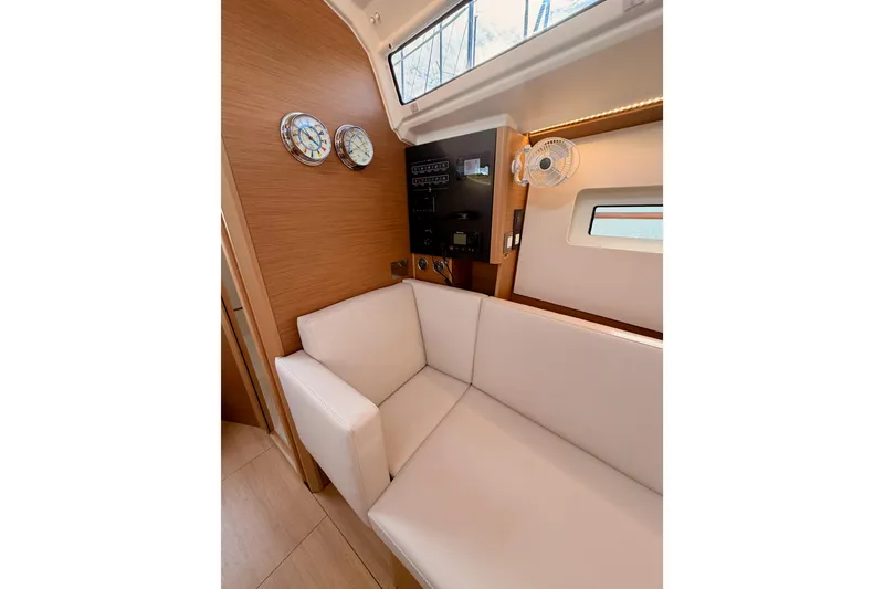 Slide: The Image of Interior of 2025 Jeanneau Sun Odyssey 350 yacht with white seating and wooden accents. - 74