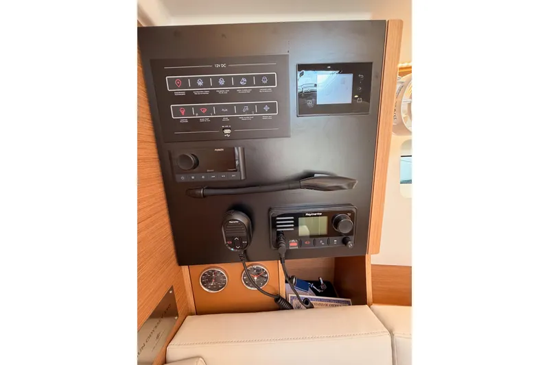 Slide: The Image of Control panel of 2025 Jeanneau Sun Odyssey 350 yacht, featuring navigation and communication equipment. - 75