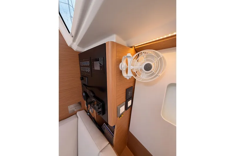 Slide: The Image of 2025 Jeanneau Sun Odyssey 350 interior with control panel and mounted fan. - 76