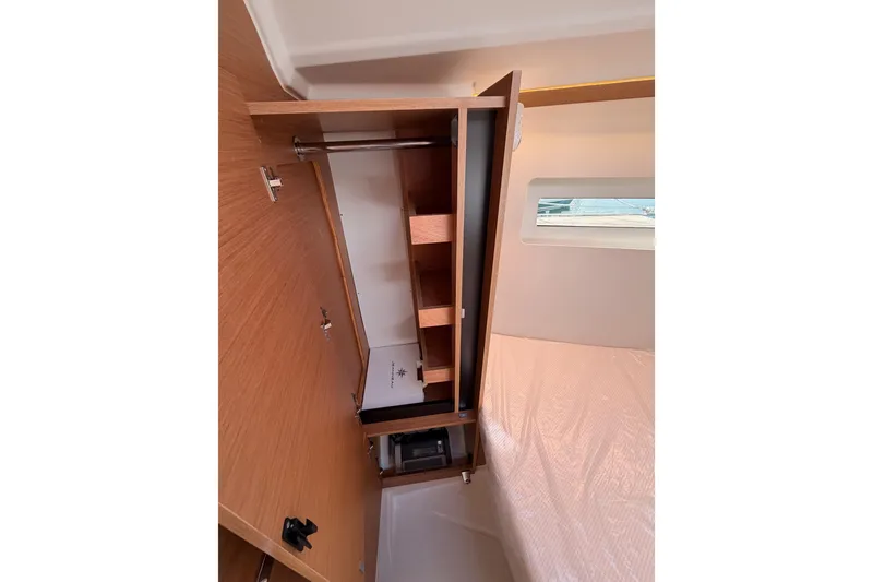Slide: The Image of Interior view of 2025 Jeanneau Sun Odyssey 350 yacht cabin with wooden storage. - 81