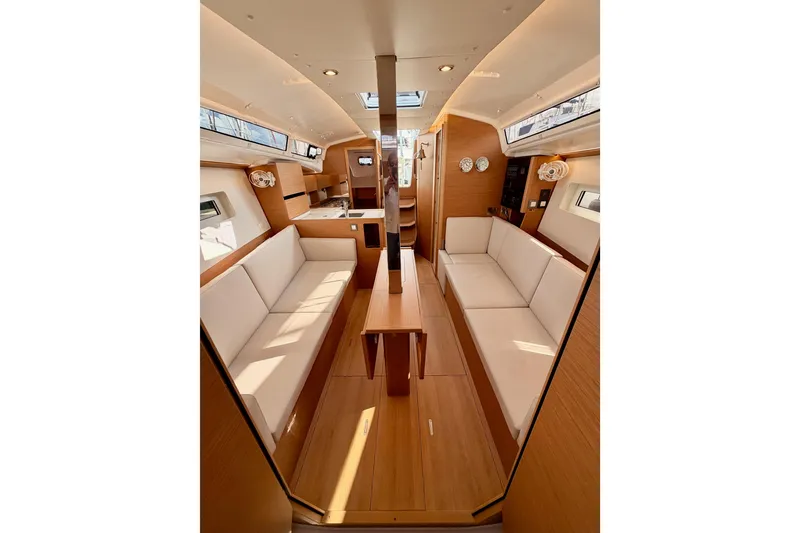 Slide: The Image of Interior of 2025 Jeanneau Sun Odyssey 350 sailboat, featuring modern seating and wood finishes. - 85