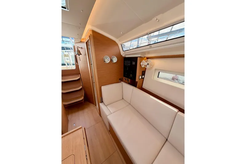 Slide: The Image of 2025 Jeanneau Sun Odyssey 350 interior with modern wood finish and comfortable seating. - 88
