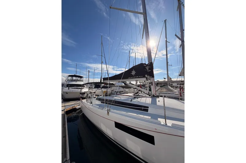 Slide: The Image of 2025 Jeanneau Sun Odyssey 350 sailboat docked at marina under clear blue sky. - 9